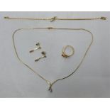 An 18ct. gold and diamond necklace, bracelet, ring and drop earrings en suite, the necklace having