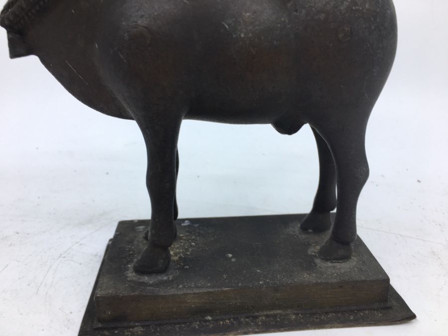 A 20th century Indian cupro-bronze lamp, fashioned as a cow carrying hinged flower form lamp, height - Image 3 of 6