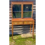 A fine quality Sheraton revival glazed bookcase with painted decoration raised on spade feet