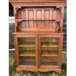 An early 20th cent arts and crafts glazed bookcase