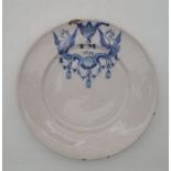 A late 17th century English Delftware plate, underglaze painted in blue with griffins and SFM 1692",
