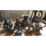 A collection of 20th century Indian and Sino-Tibetan copper and white metal mounted tea pots and
