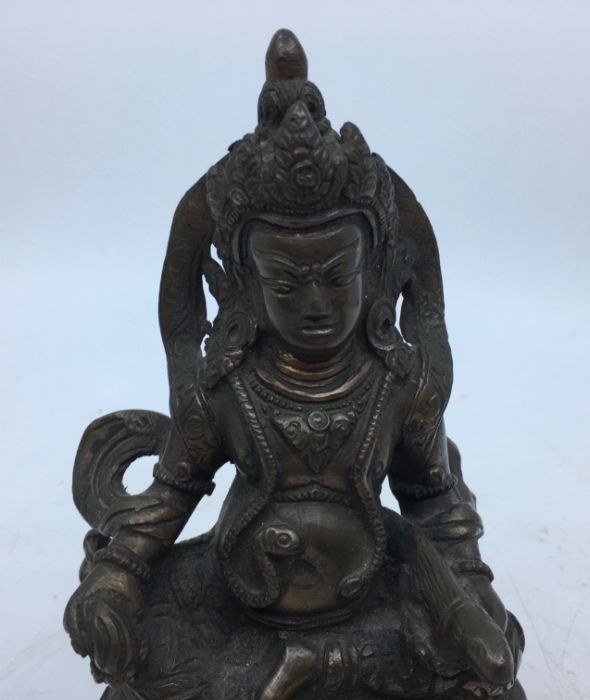 A 20th century Sino-Tibetan bronze figure of Jambhala, height 16cm. - Image 2 of 5