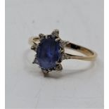 An 14ct. gold, sapphire and diamond ring, set mixed oval cut sapphire (ESW approx. 1.25 carats),