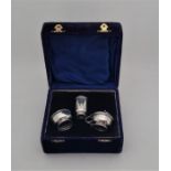 A silver three piece cruet set, in fitted case, by Adie Brothers Ltd, Birmingham 1926, the mustard