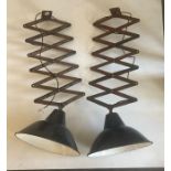 A pair of industrial enamel lamps