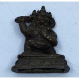 A small 20th century Sino-Tibetan bronze figure of a protective deity, height 5.7cm.