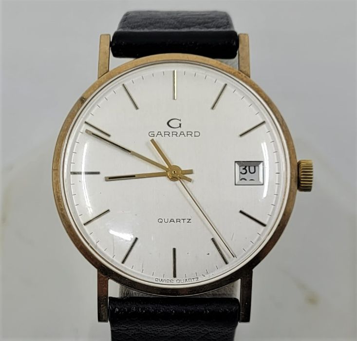 A Garrard 9ct. gold gentleman's quartz wrist watch, c.1984, having signed circular silvered dial