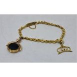 A precious yellow metal fancy link charm bracelet, suspending black onyx and jade set swivel fob and