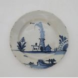 An 18th century English Delftware plate, painted in blue, diameter 20.5cm. Condition note: loss of