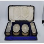 A cased set of four silver dressing table brushes, by Levi & Salaman, Birmingham 1924-25, engine