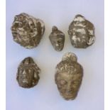 A collection of early carved Indian stone heads. (5)
