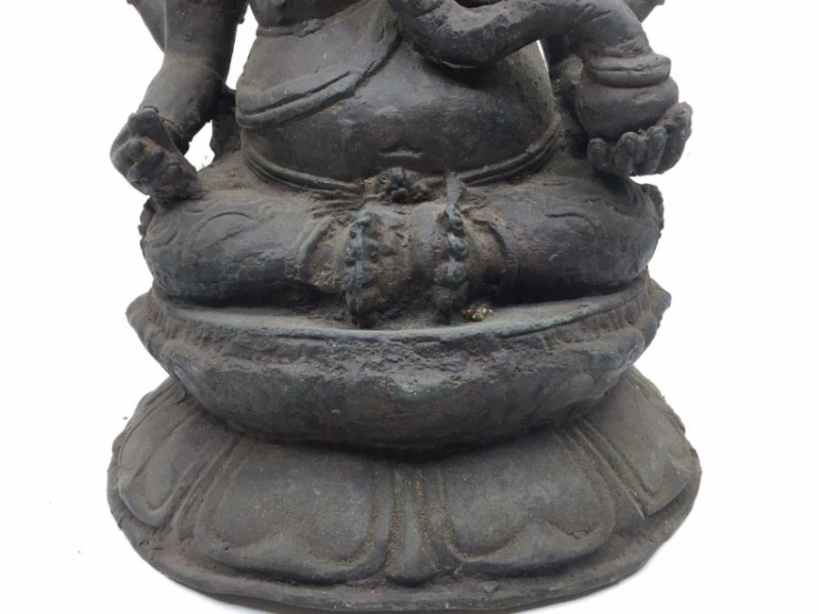 A late 20th century Indian bronze figure of four armed Ganesha seated, height 29cm. - Image 3 of 5