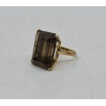 A 9ct. gold and smokey topaz dress ring, set mixed rectangular cut smokey topaz. (gross weight 8.