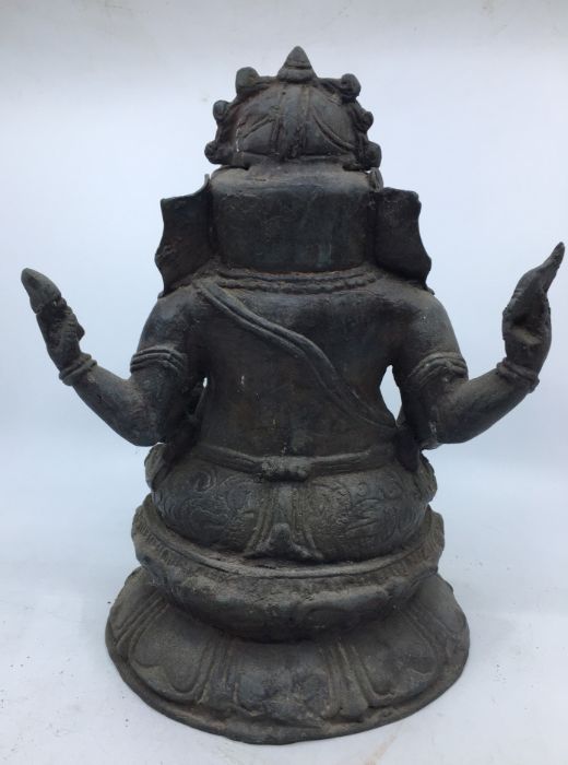 A late 20th century Indian bronze figure of four armed Ganesha seated, height 29cm. - Image 4 of 5