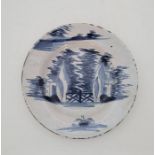 An 18th century English Delftware plate, painted in blue, diameter 23.1cm. Condition note: loss of