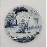 An 18th century English Delftware plate, painted in blue, diameter 20.6cm. Condition note: loss of