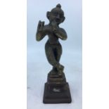 A 20th century Indian bronze figure of Lord Krishna playing flute, height 23.5cm.