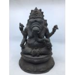 A late 20th century Indian bronze figure of four armed Ganesha seated, height 29cm.