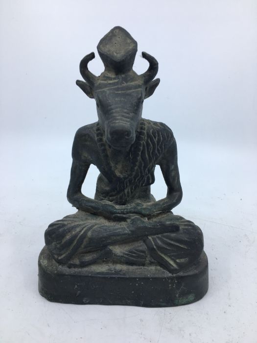 A 20th century Indian bronze figure of a seated deity, height 20cm.