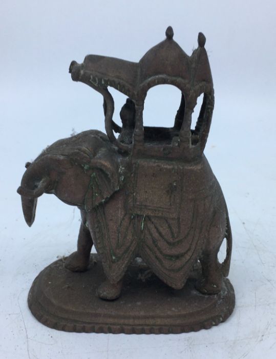 A 20th century Indian bronze figure of an elephant with rider, height 15cm.