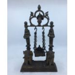 A 20th century Indian bronze figural lamp, having twin elephant supports with figural lamps to