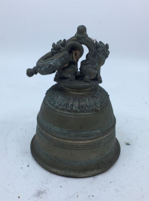 An early 20th century Sino-Tibetan bronze bell, lacking clapper, height 19cm.