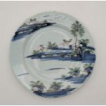 An 18th century English Delftware plate, painted in colours, diamrter 22.5cm. Condition note: a