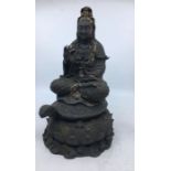 A 20th century Chinese bronze figure of Guanyin, seated upon tortoise, traces of gilt remaining,