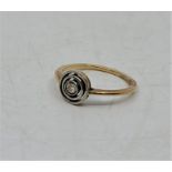 A precious yellow metal and diamond target ring, bezel set central old-cut diamond within pierced