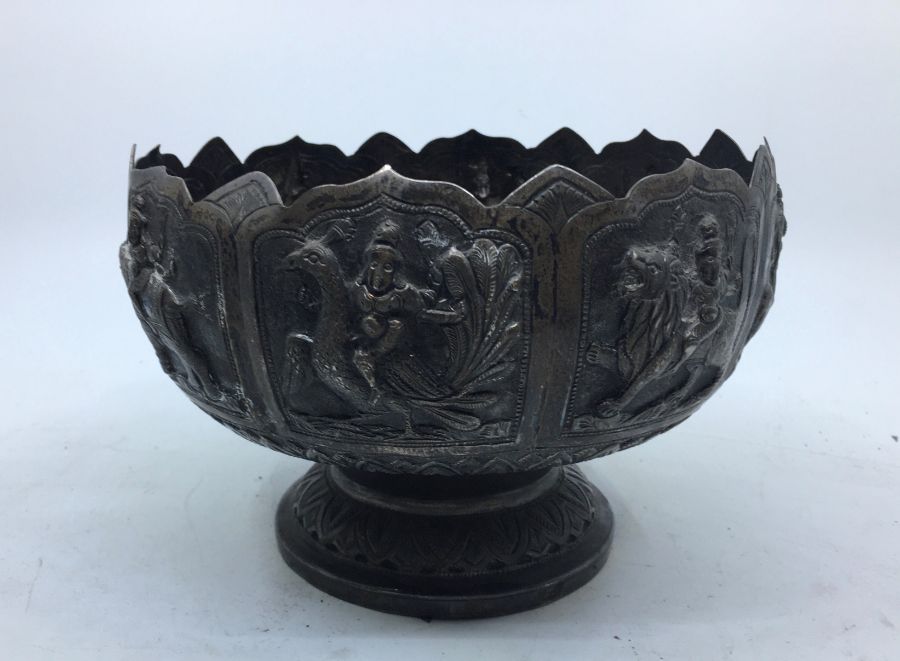 A late 19th/early 20th century Indian white metal pedestal bowl, having eight repousse panels to