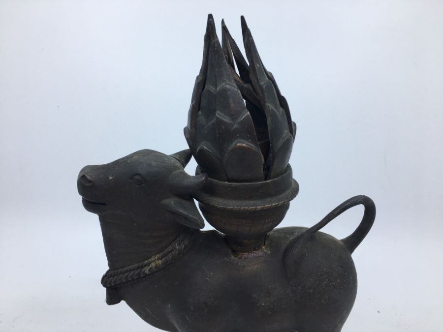 A 20th century Indian cupro-bronze lamp, fashioned as a cow carrying hinged flower form lamp, height - Image 2 of 6