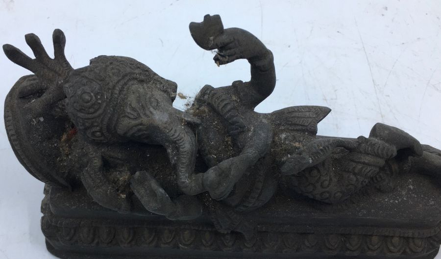 A 20th century Indian bronze figure of reclining four armed Ganesha, length 17.5cm. - Image 2 of 4