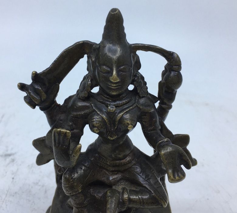An 18th/19th century Indian bronze figure of a four armed deity, height 12cm. - Image 2 of 5