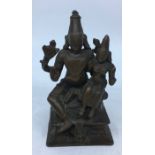 A small 19th century (or earlier) Indian bronze figural group of Lakshsmi-Narayana, four armed