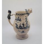 A large 18th century English Delftware water jug, painted in blue, having figural handle and lions