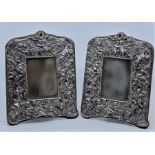 A pair of sterling silver easel back table mirrors, repousse cherubs, height 27.5cm. (2)