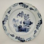 An 18th century English Delftware charger, painted in blue, diameter 35.3cm, height 5.5cm. Condition