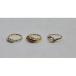 An 18ct. gold and platinum three stone diamond ring, illusion set, size UK M (gross weight 2.2g),