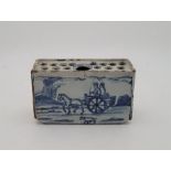 An 18th century English Delftware flower brick, painted in blue, N.C.S. Exhibition Leeds 1974
