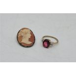 A 9ct. gold and spinel ring, set mixed oval cut spinel to centre with four clear stones to each