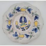 A late 17th/early 18th century Delftware octofoil lobed dish, painted in yellow, blue and green,