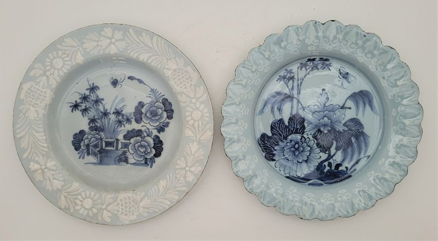 Two mid 18th century English Delftware plates, both with blue ground and with rim painted bianco-