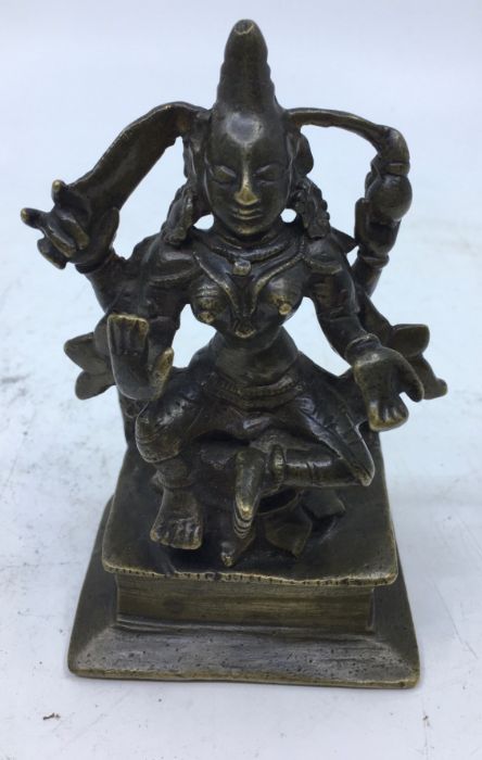 An 18th/19th century Indian bronze figure of a four armed deity, height 12cm.