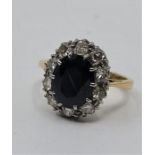 An 18ct. gold and platinum, sapphire and diamond ring, having mixed oval cut sapphire to centre (ESW