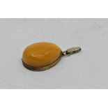 A Russian silver and butterscotch amber tear drop shaped pendant, impressed post 1958 Russian