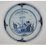 A late 18th century Lambeth Delftware charger, painted in blue, diameter 33.5cm, height 4.5cm.