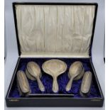 A cased silver six piece dressing table set, by Daniel Manufacturing Company, Birmingham 1928,