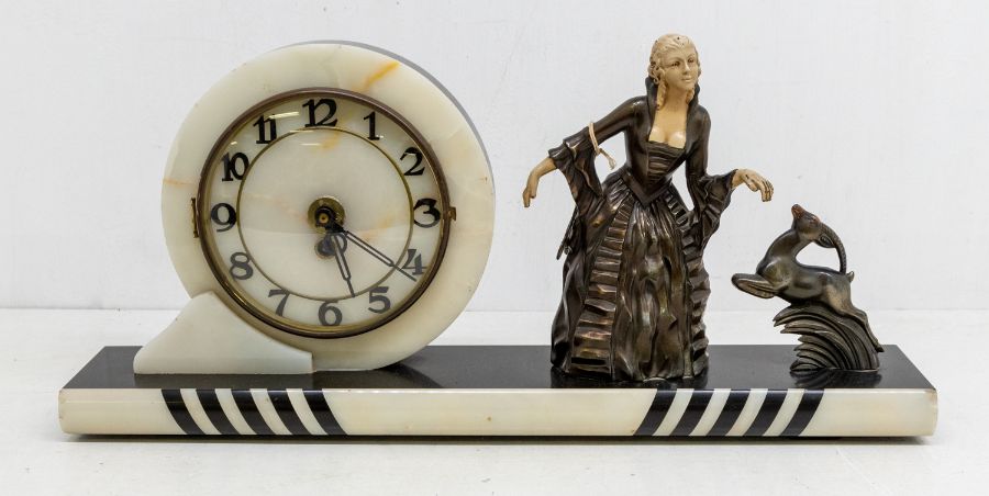 An Art Deco style clock garniture of circular marble design with spelter figure of a female and a
