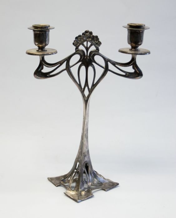 An Art Nouveau WMF Silver Plated candlestick with a decorative stylised floral design and pierced